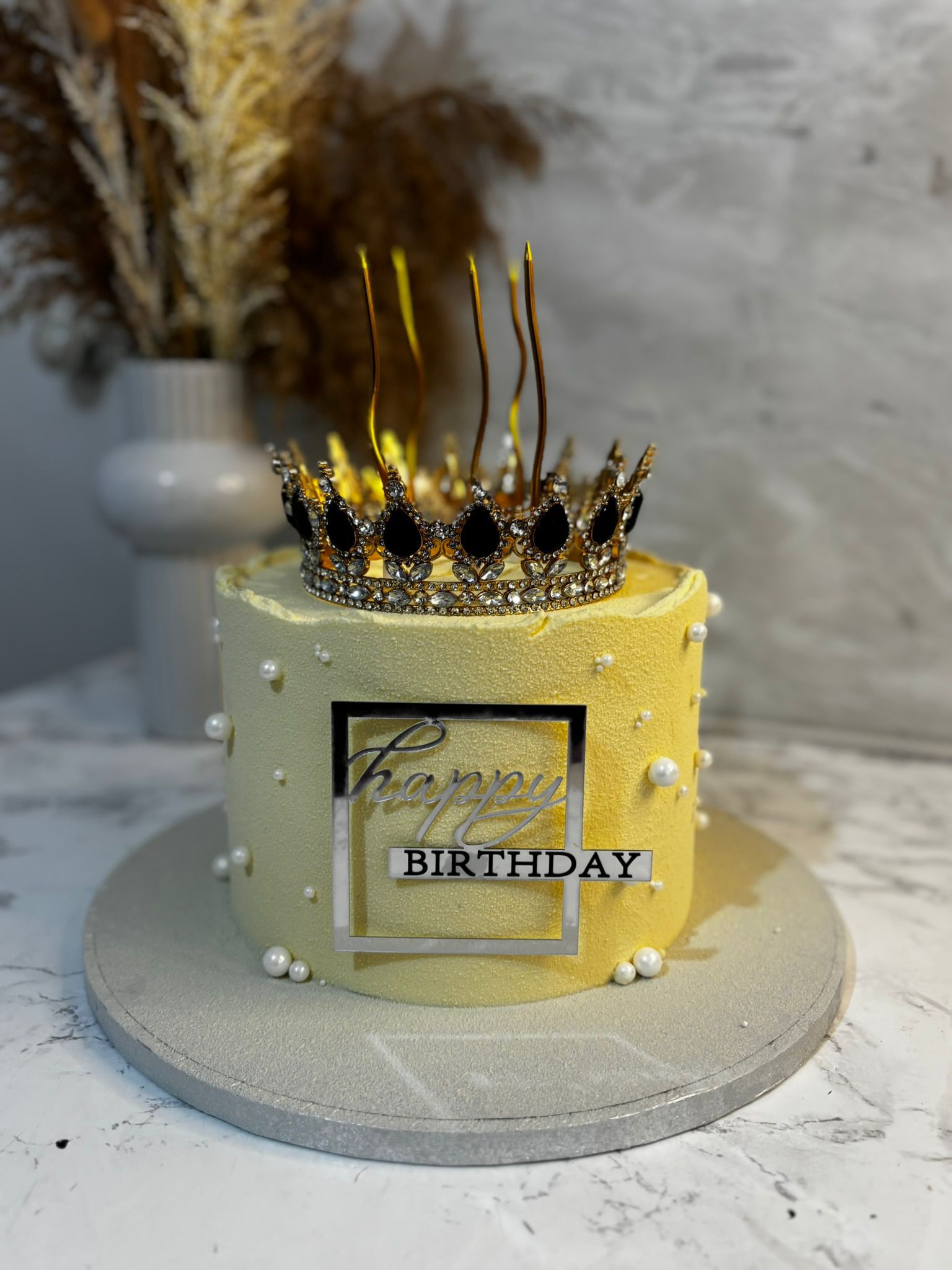 Gold velvet cake with decorative crown and birthday plaque
